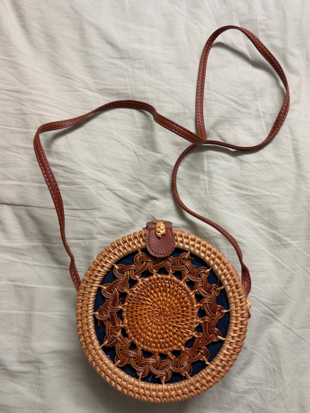 Round Woven Crossbody Bag in Brown with Navy Accent